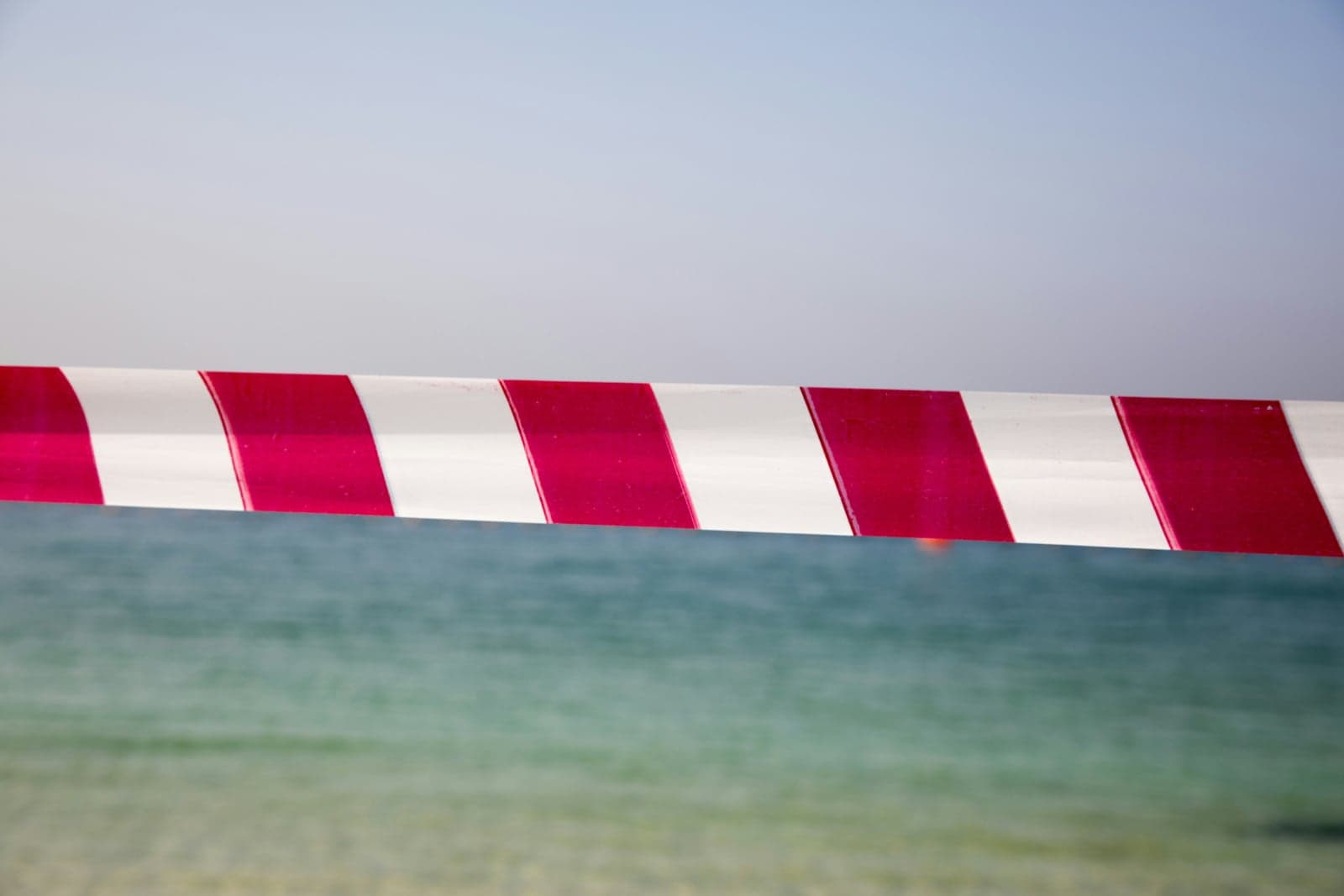 Picture of the sea with red and white barrier tape