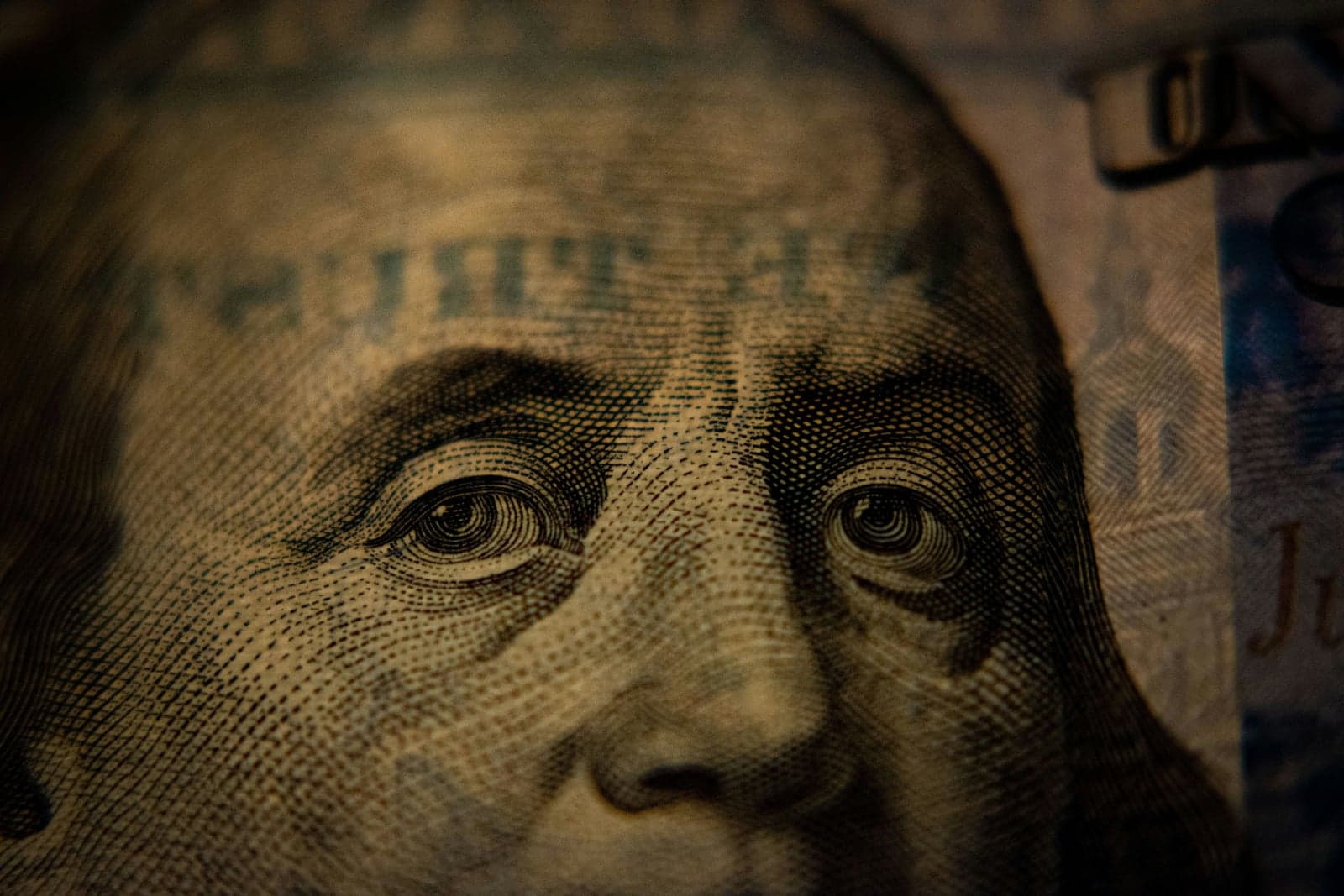 Picture of a 100$ bill zoomed in on President Benjamin Franklin