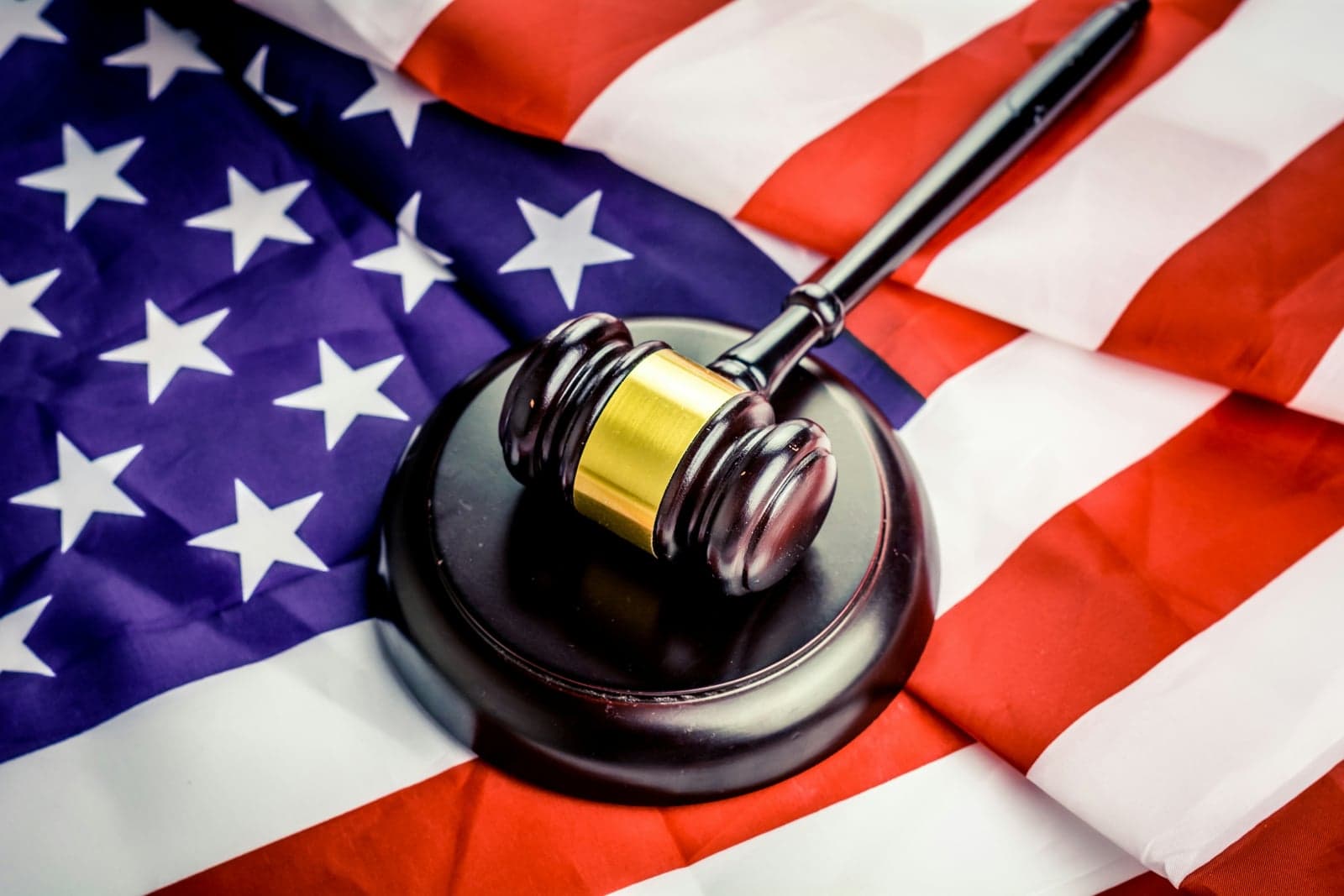 Picture of a judge's gavel on top of the American flag